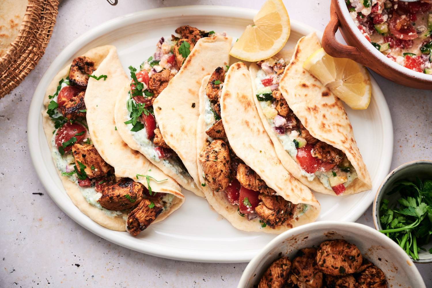 25 High Protein Dinners (30g and Up!) Mediterranean chicken tacos with cucumber tomato salsa, feta cheese, olives, and tzaztziki.