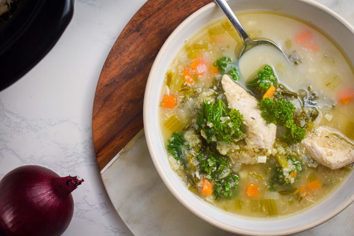 Slow Cooker Chicken Quinoa Soup with Kale Slow cooker chicken quinoa soup with kale, carrots, celery, and onions in a bowl with a spoon.