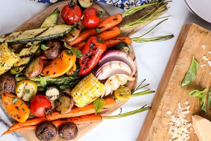 Grilled Vegetables Grilled vegetable skewers seen from above on a beautiful round plate pictured on a marble top table.