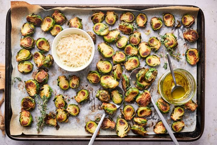 Roasted Brussel Sprouts Simple roasted brussels sprouts on a baking sheet with crisp edges and Parmesan cheese.