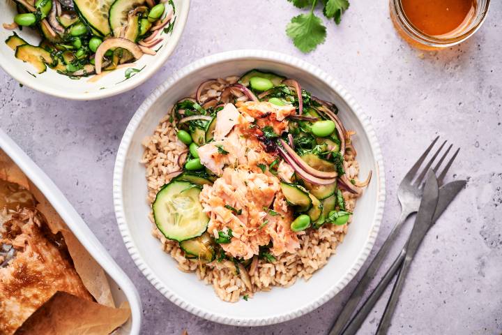 Salmon Rice Bowls Salmon rice bowls with Asian salmon, cucumbers, edamame, red onion, herbs, and cooked brown rice.