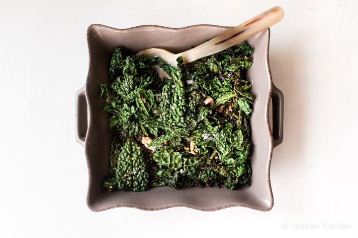 Sauteed Kale Sauteed kale with garlic, red wine vinegar, salt, and pepper in a ceramic dish.