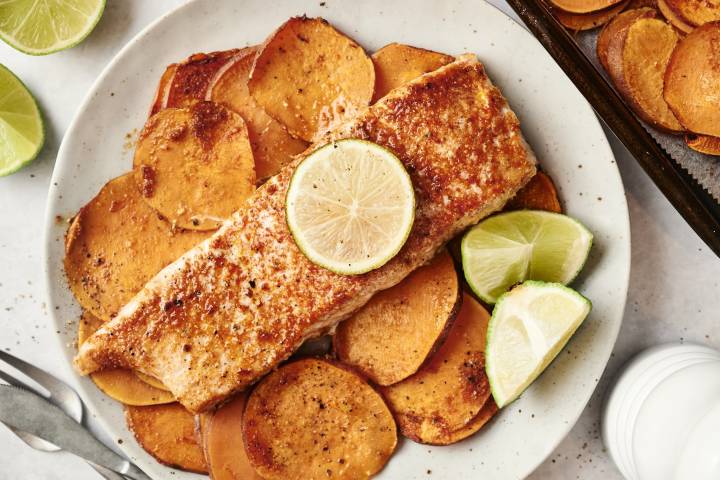 Southwest Salmon with Sweet Potatoes Spiced salmon fillet with a lime slice, served over roasted sweet potatoes.