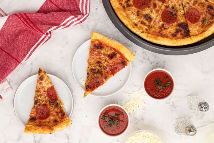 Two Ingredient Pizza Dough Two ingredient pizza dough with Greek yogurt and self rising flour then topped with melted cheese, sauce, and pepperoni,