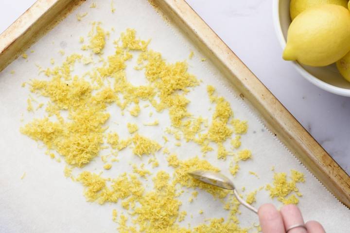 How To Make Lemon Pepper Seasoning Lemon zest spread put on a baking sheet with parchment paper.