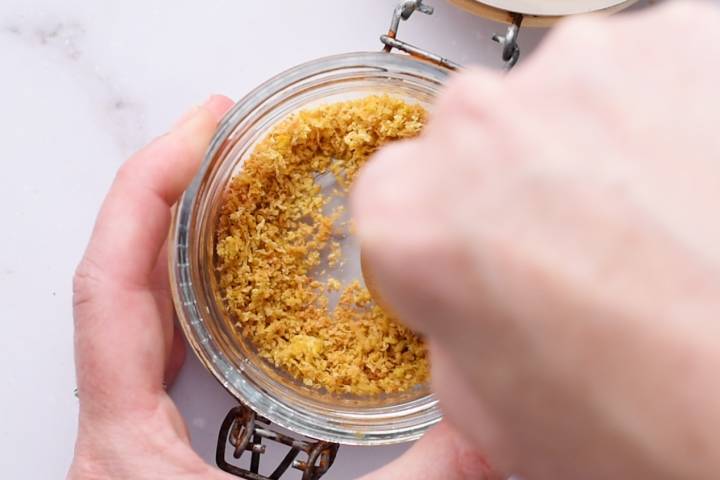 How To Make Lemon Pepper Seasoning Lemon zest being chopped into smaller pieces.