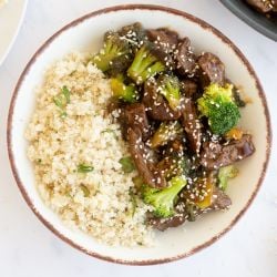 Healthy Beef and Broccoli Healthy beef and broccoli served on a plate with steamed rice.