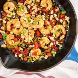 Kung Pao Shrimp Kung Pao Shrimp with peanuts, celery, red peppers, and green onions in a skillet.