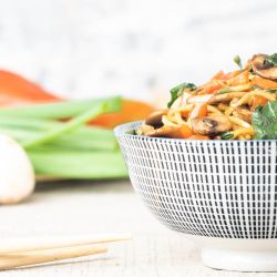 Spinach and Mushroom Lo Mein Spinach and Mushroom lo mein in a bowl with chopsticks picking up noodles.
