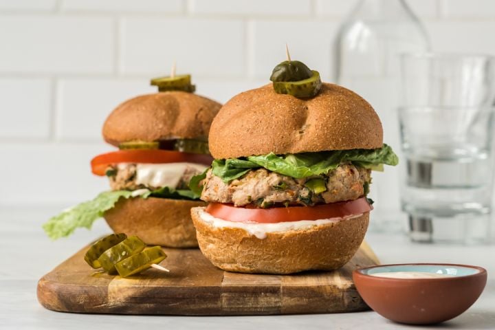 Asian Turkey Burgers Asian turkey burgers with lettuce, tomato, and sweet chili yogurt sauce on two buns,