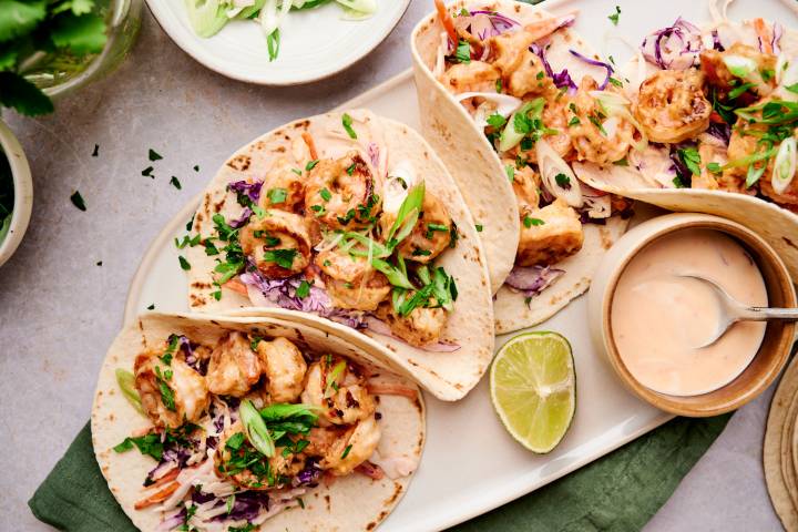 Bang Bang Shrimp Tacos Bang bang shrimp tacos with creamy coleslaw, cilantro, green onions, and crispy shrimp in corn tortillas.