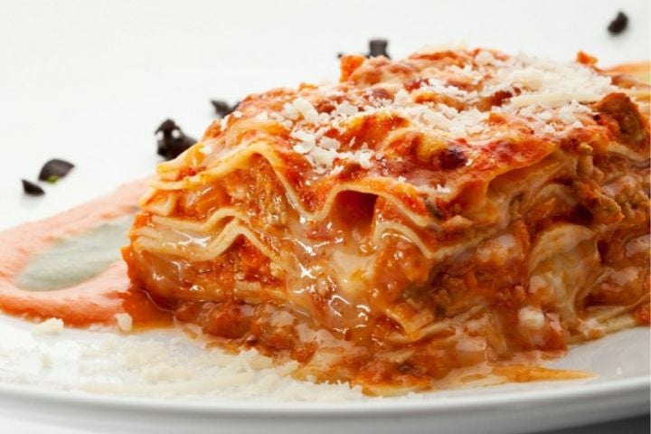 Five Ingredient Chicken Parmesan Lasagna (Slow Cooker or Stove) Chicken Parmesan lasagna with ricotta cheese and cooked chicken on a plate.