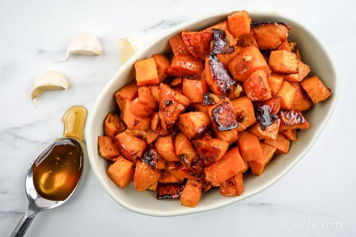 Honey Roasted Sweet Potatoes Roasted sweet potatoes with garlic cloves and a spoonful of honey.