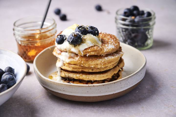 Low Carb Almond Flour Pancakes Low carb almond flour pancakes on a plate with blueberries, yogurt, and maple syrup.