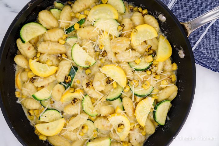 Potato Gnocchi with Zucchini and Corn Gnocchi with zucchini and corn in cream sauce in a skillet.