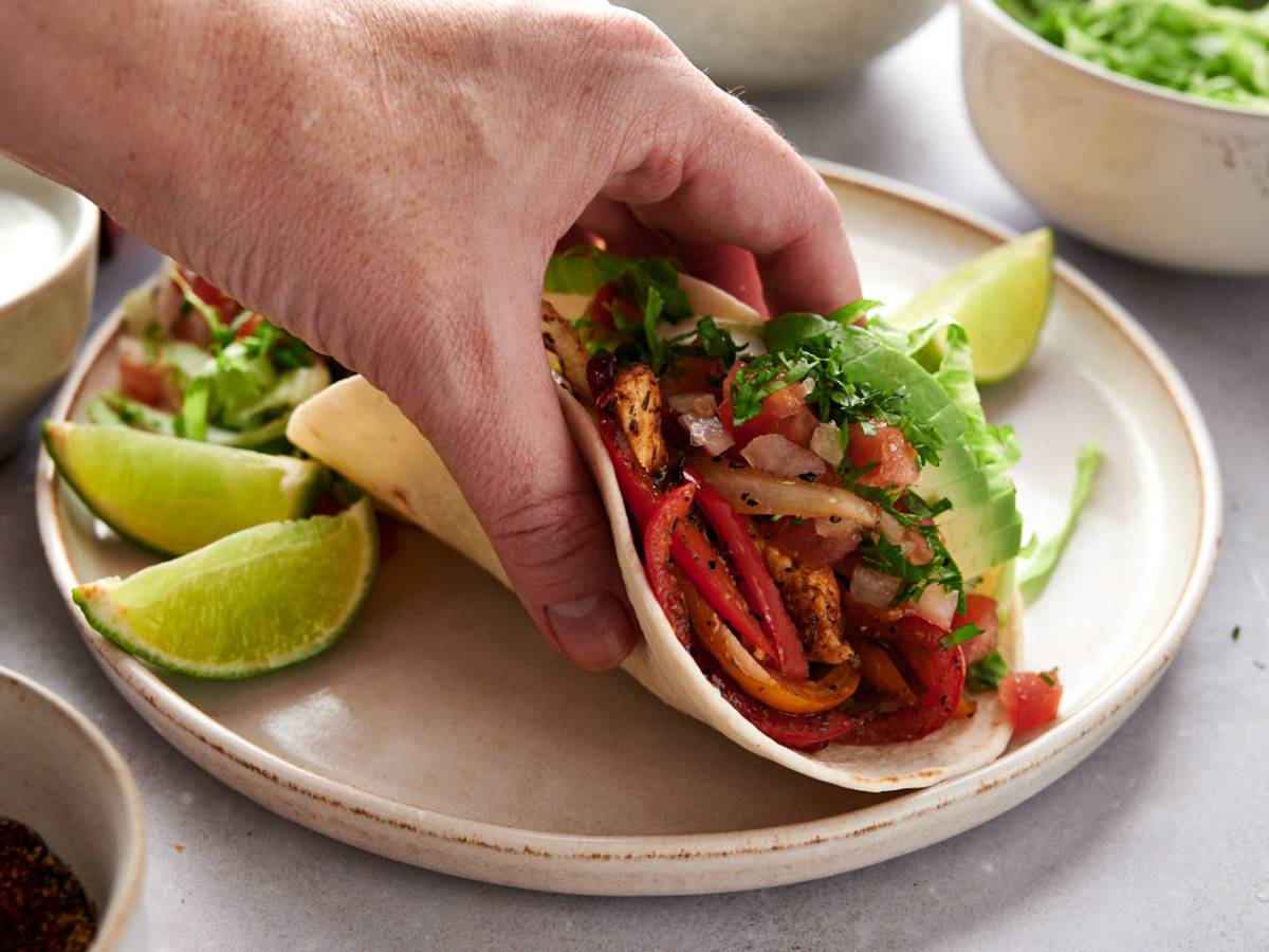 Beef Tacos Fajita soft taco with chicken breast, peppers, onions, sour cream, avocado, and salsa