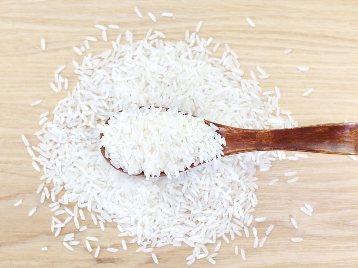 Healthy Rice Recipes White rice on a wooden surface and a wood spoon