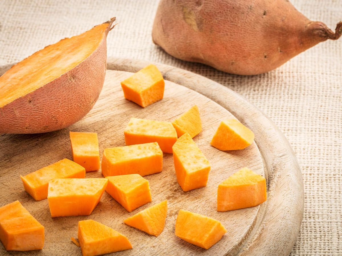 Healthy Sweet Potato Recipes Diced sweet potato on a wood cutting board