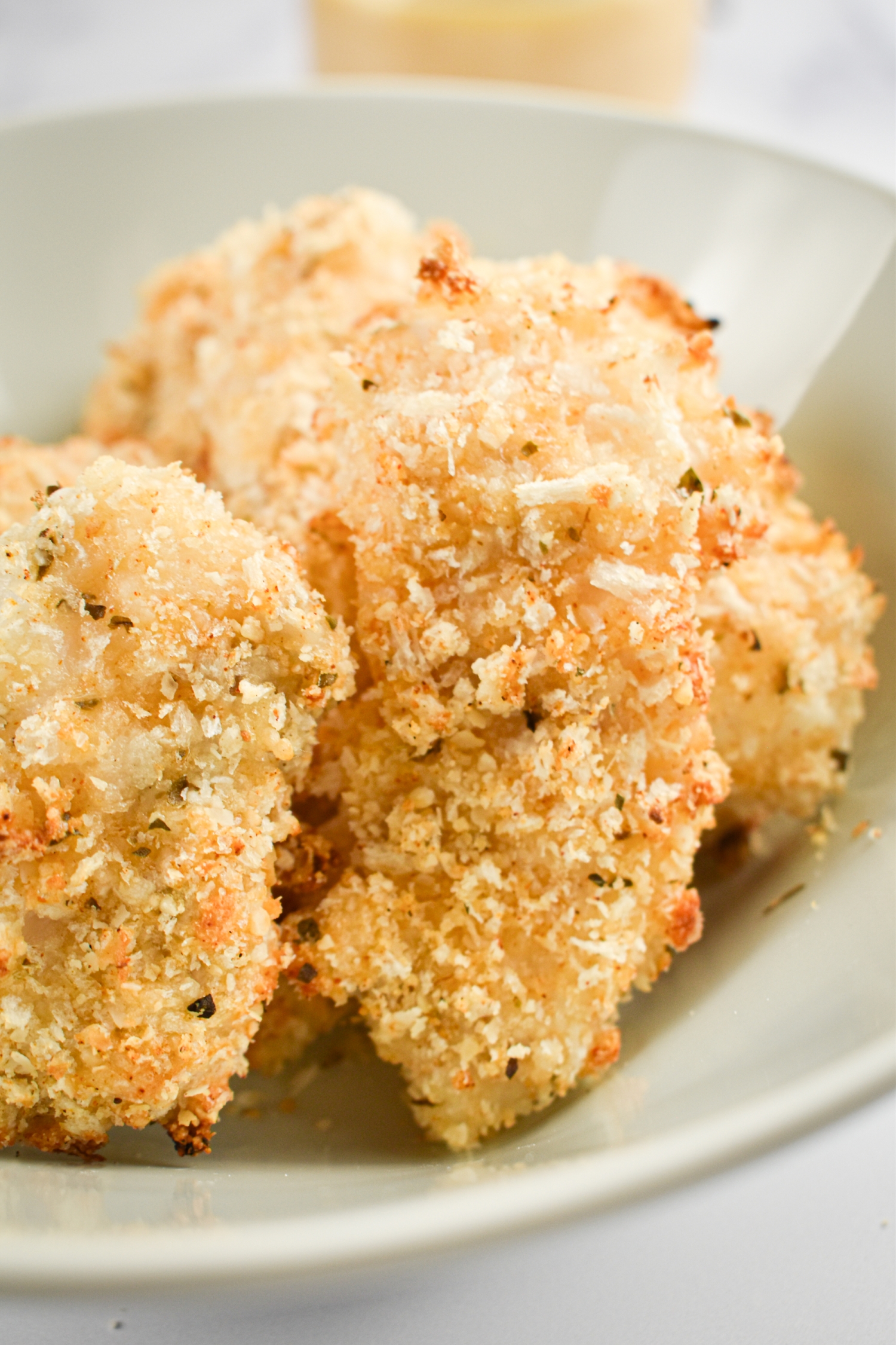 Homemade crispy fish sticks in a bowl with Panko breadcrumbs.