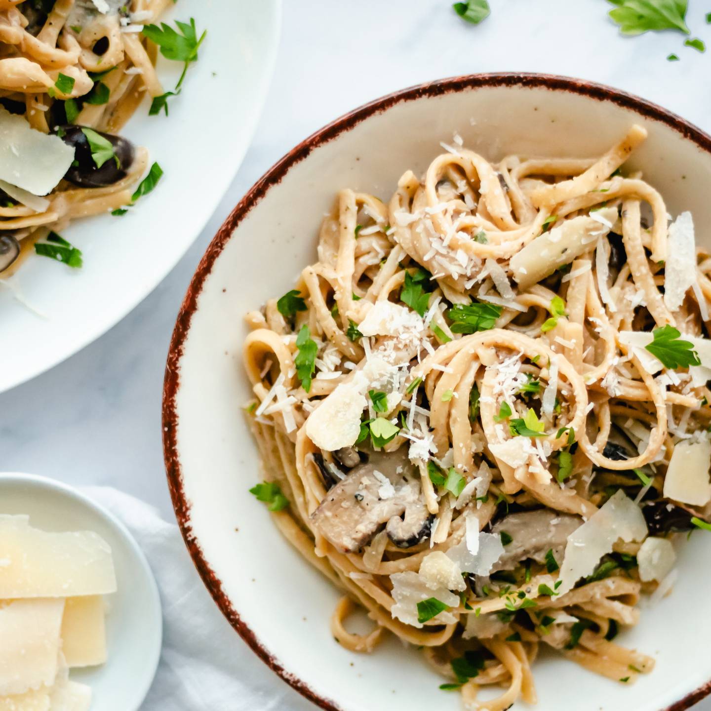 Mushroom pasta with a creamy sauce in a bowl with a spoon.