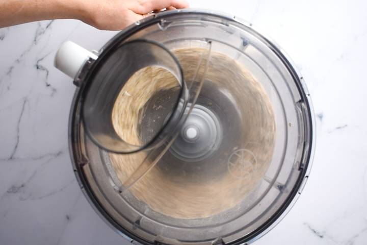 Rolled oats being pulsed in a food processor.