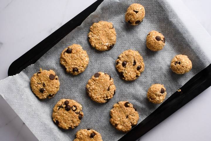Oatmeal banana cookies on a baking sheet with parchment paper.