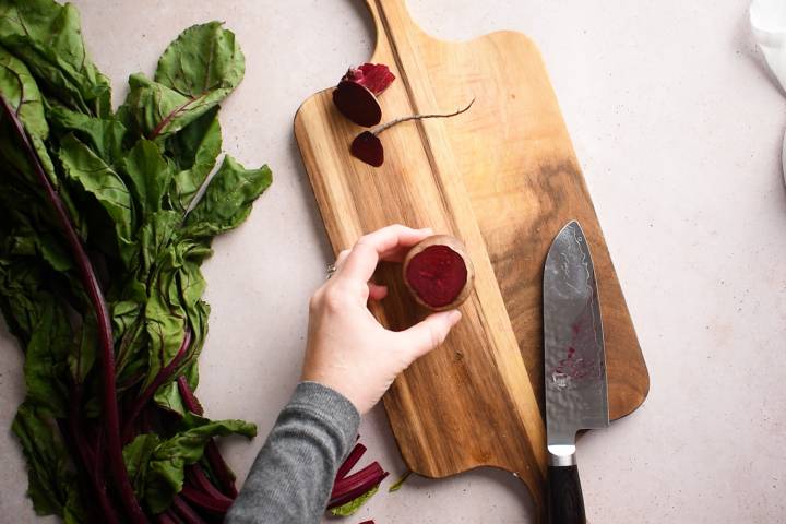 Beets being chopped on a cutting board.
