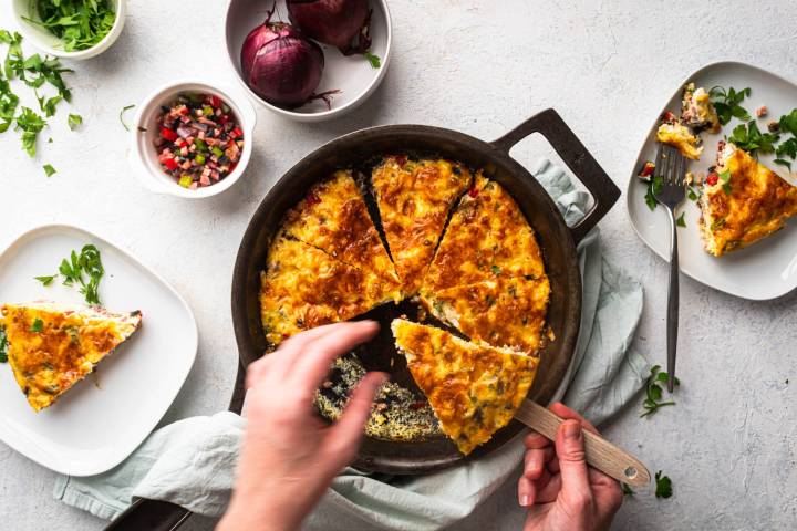 Western omelet frittata cit into slices and being served.