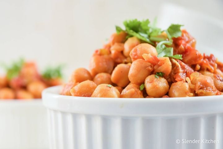 Slow Cooker Chana Masala in a bowl with chickpeas in a curry tomato sauce.