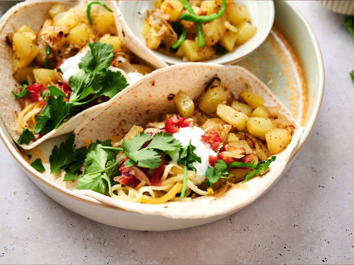 Potato green chile tacos with chopped potatoes, poblano peppers, onions, and salsa served in corn tortillas.